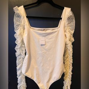 NWT Free People bodysuit with ruffled sleeves.